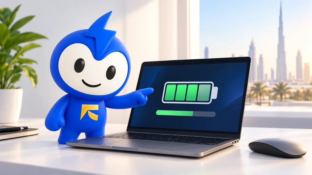 A blue cartoon mascot stands next to a laptop displaying a battery charging icon to check laptop battery health, with a city skyline in the background.